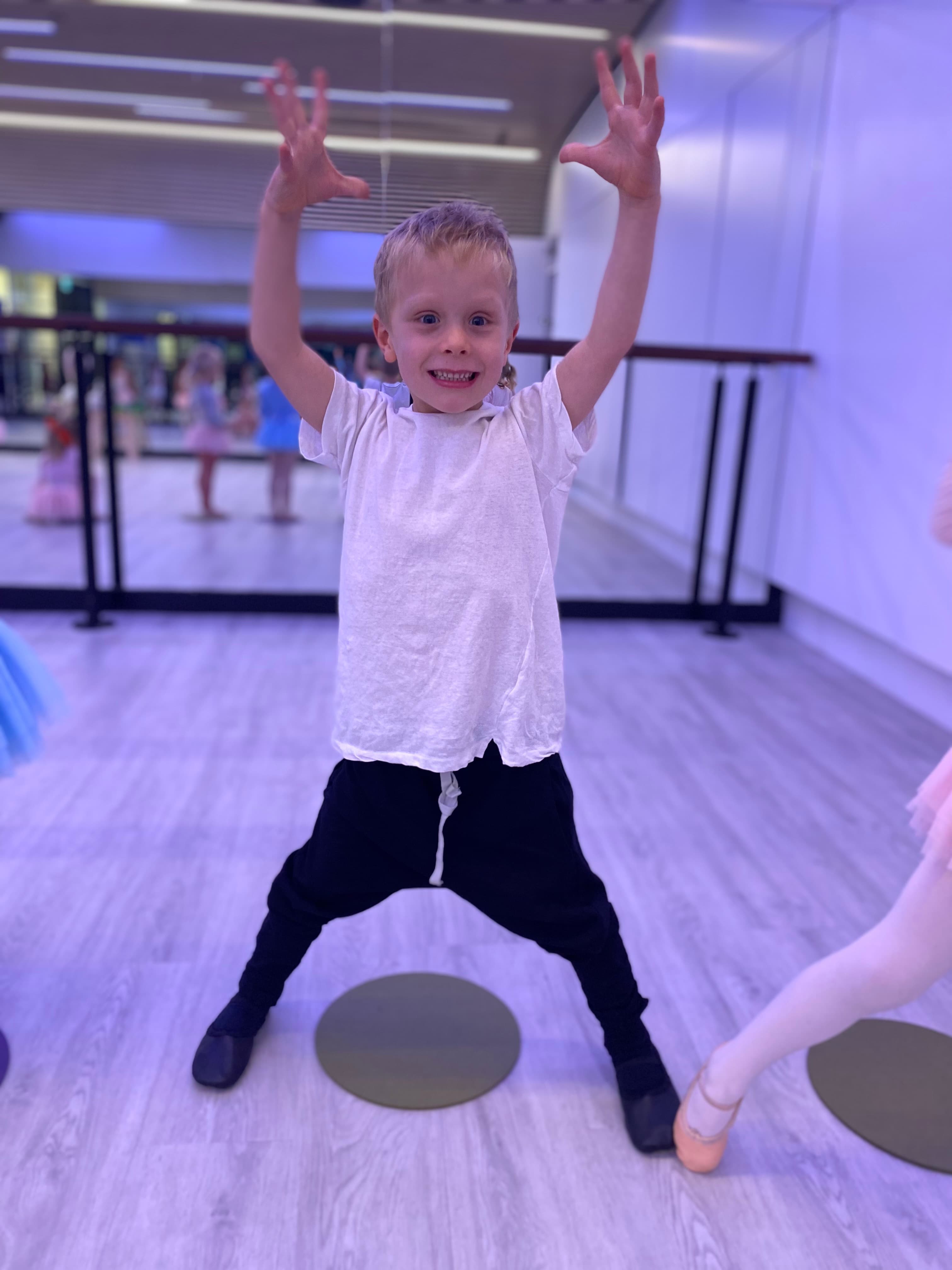 Boy posing with hands up